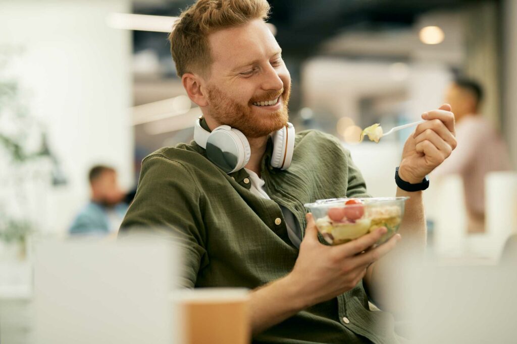 Man In Green Shirt Earring A Bowl Of Food